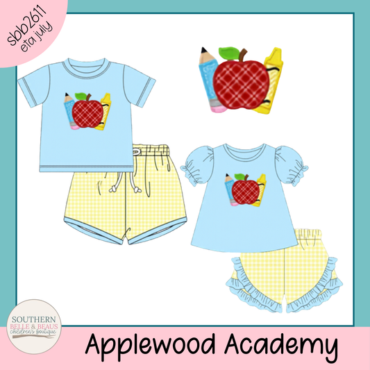 Children's clothing set with shirts and shorts featuring an apple design, branded 'Applewood Academy'.